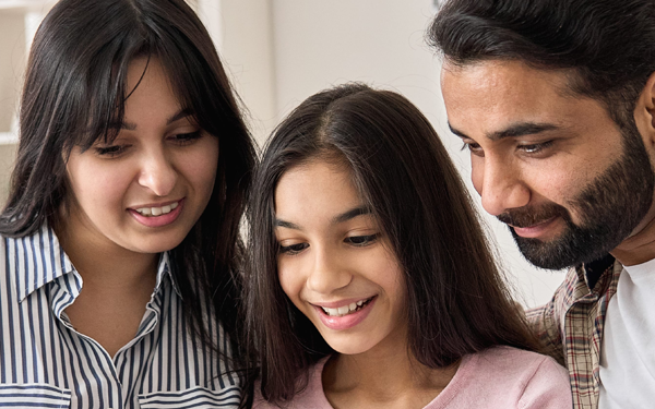 teenage girl with her mother and father by her side